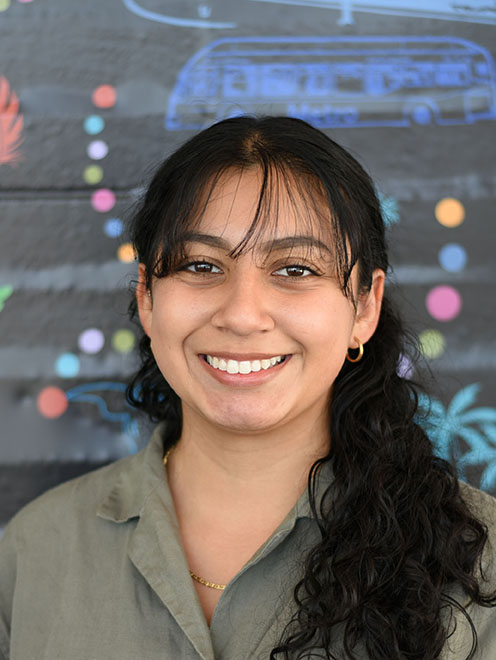 A person with long hair smiling.