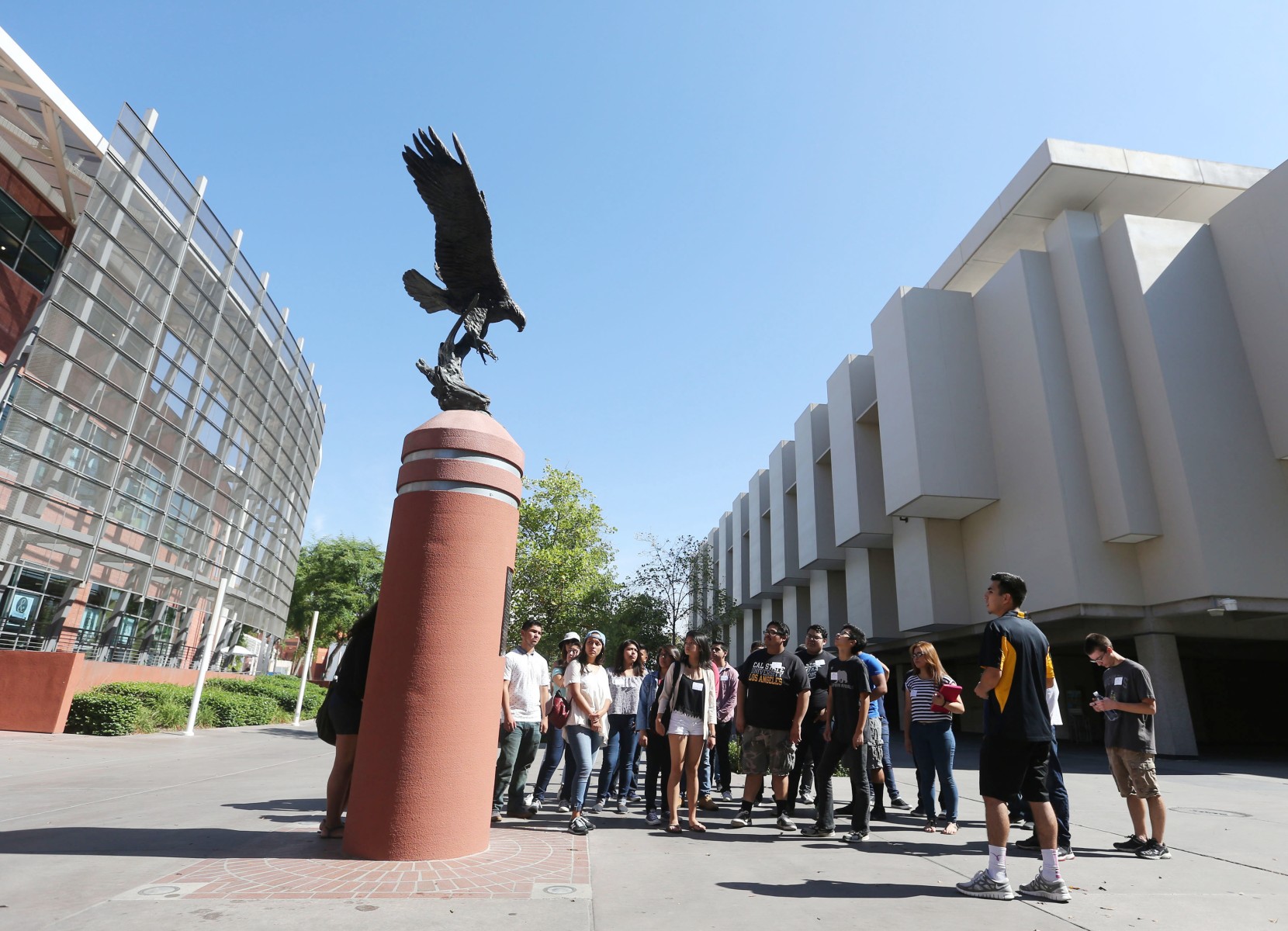 Students standing around the Golden Eagle statue behind the bookstore