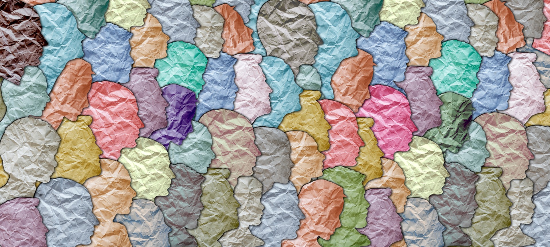 Paper cutouts of facial profiles in multiple colors arranged in a collage.