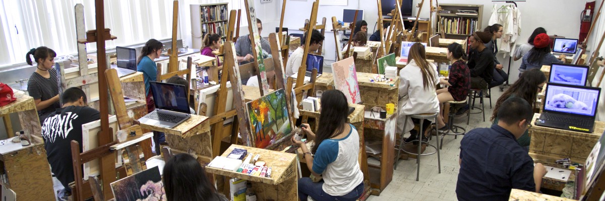 Students painting on easels in a classroom