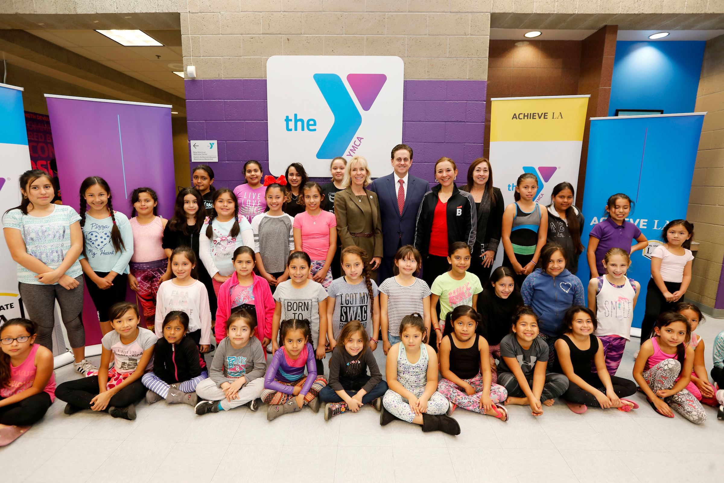 Cal State LA Vice President for Advancement Janet S. Dial, Cal State LA Executive Vice President Jose A. Gomez, Ballet Hispánico's Gabriela Estrada and Southeast-Rio Vista YMCA Executive Director Patricia Renteria with children at the dance workshop