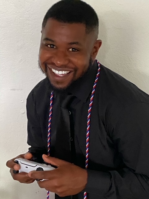 Person smiling holding a gaming controller