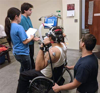 BMES Students working on project with man in wheelchair