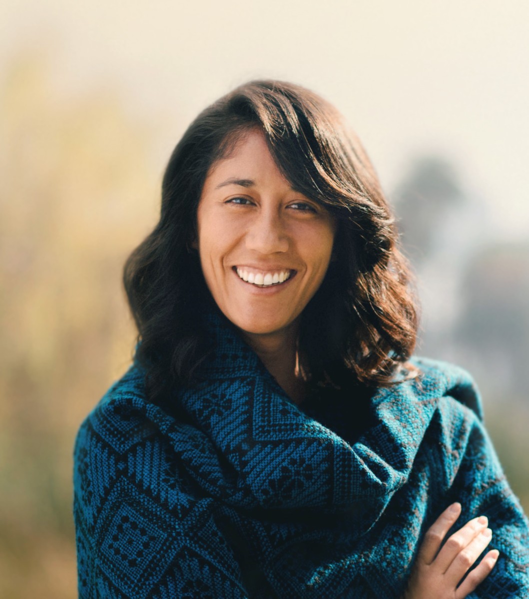 Woman smiling and wearing green clothing