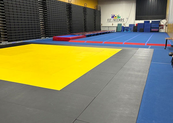 The inside of a physical education room with padded flooring.
