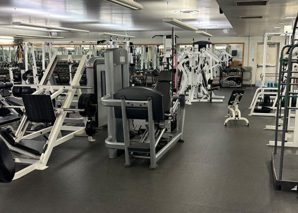 The inside of a gym with many exercise stations.