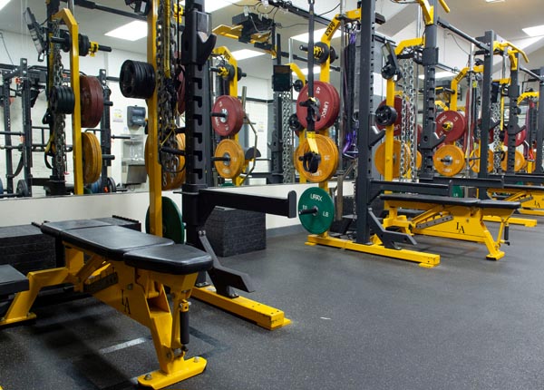 A weight room with exercise equipment
