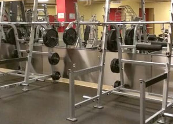 A weight room with exercise equipment.