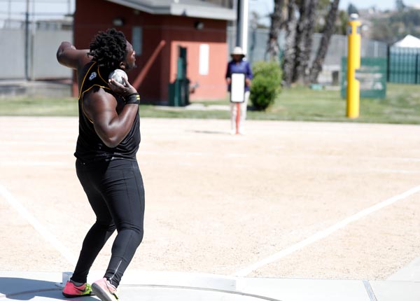 An athlete performing the shot put.