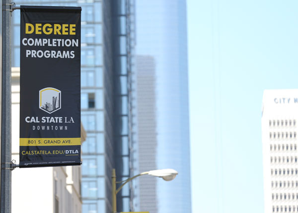 A banner hanging from the side of a building.