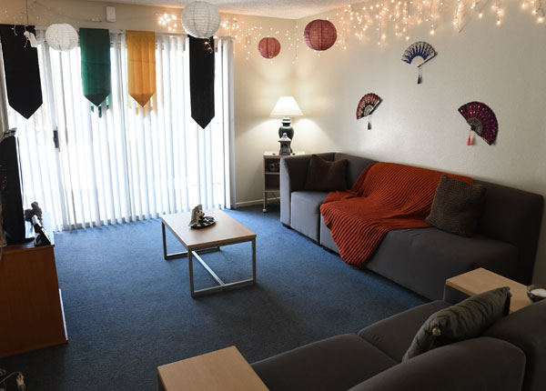 A living room with a large red couch in it.