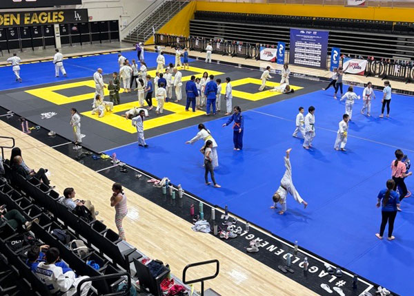 A judo tournament in a gym.