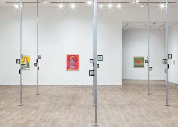 The inside of an art gallery with art on the walls.