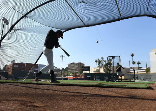 A batter hitting the baseball.