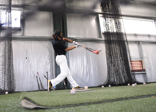 A batter hitting the baseball.