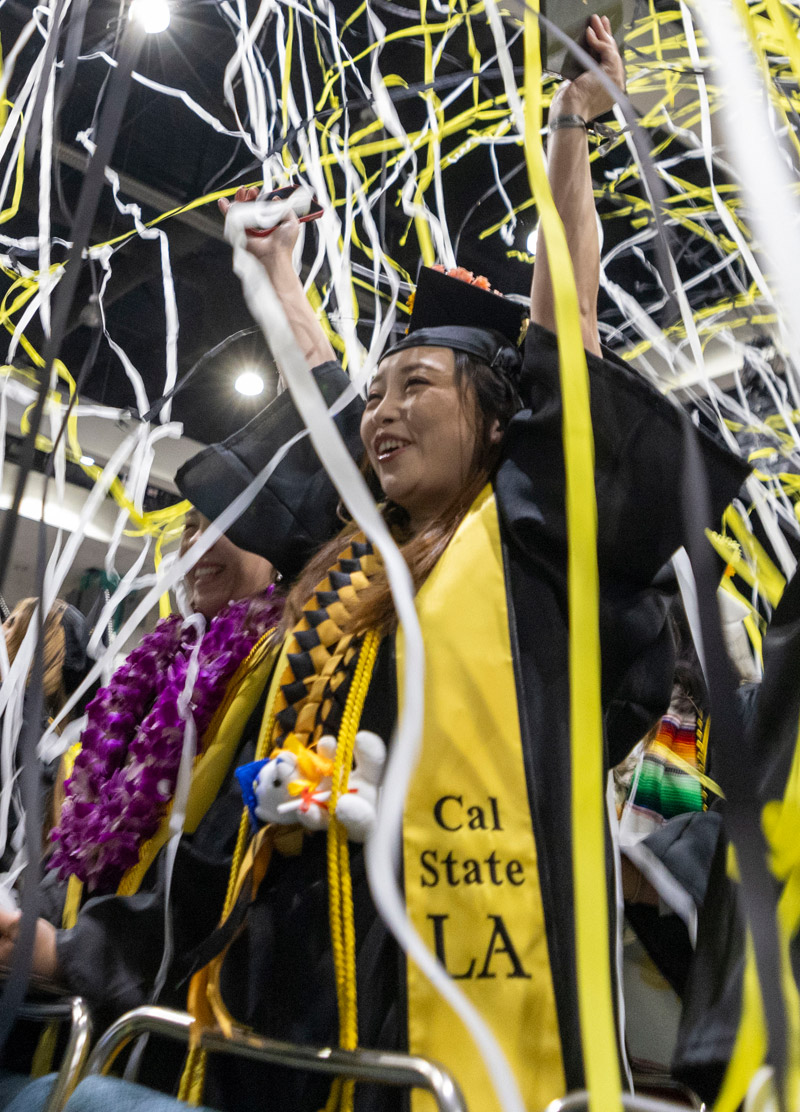 A student holds her diploma at graduation ceremony.