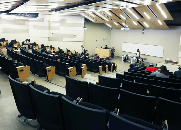 A large conference room with stadium-like seating.