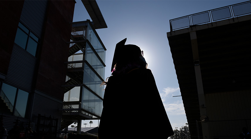 A shadow of a student in regalia