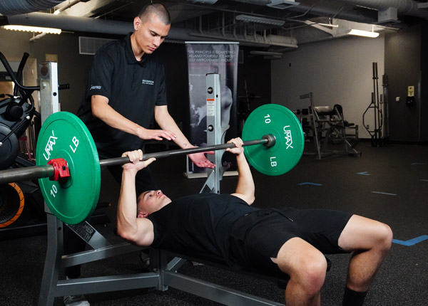 A person lifting weights in a gym.