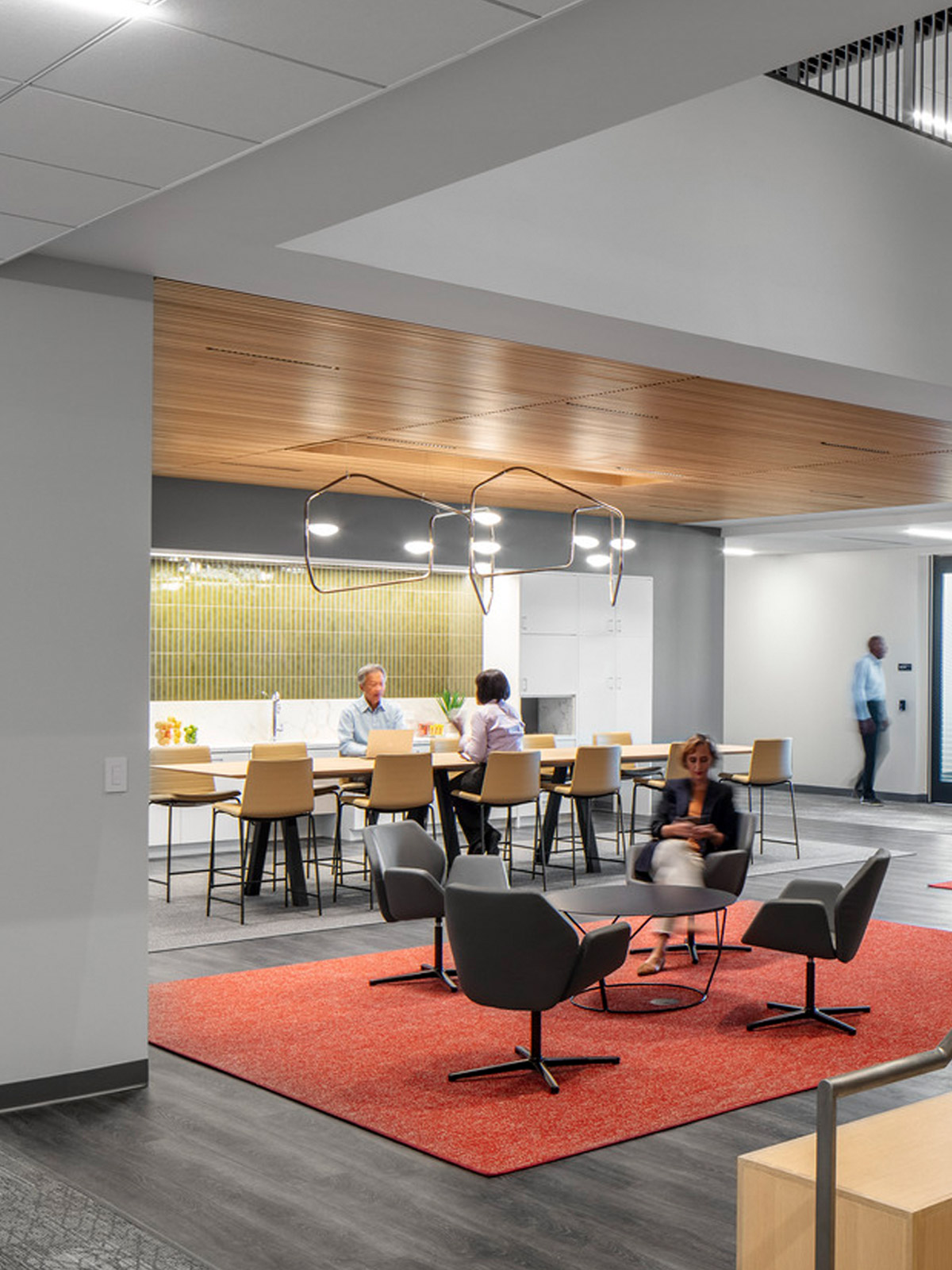 The inside of a furnished office building with people occupying it.