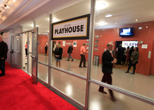 The front entrance of a building with a sign that reads "State Playhouse" on the front of it.