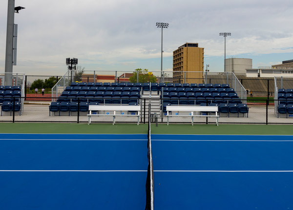A tennis court on a sunny day.