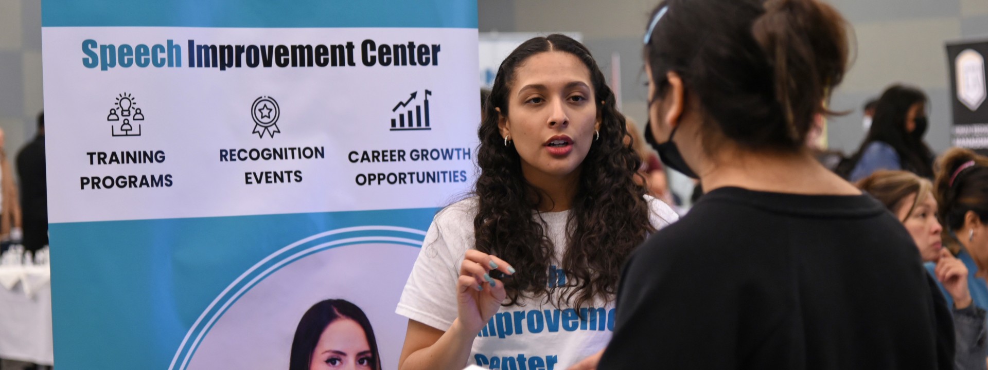 Student speaking with an employer at a career fair