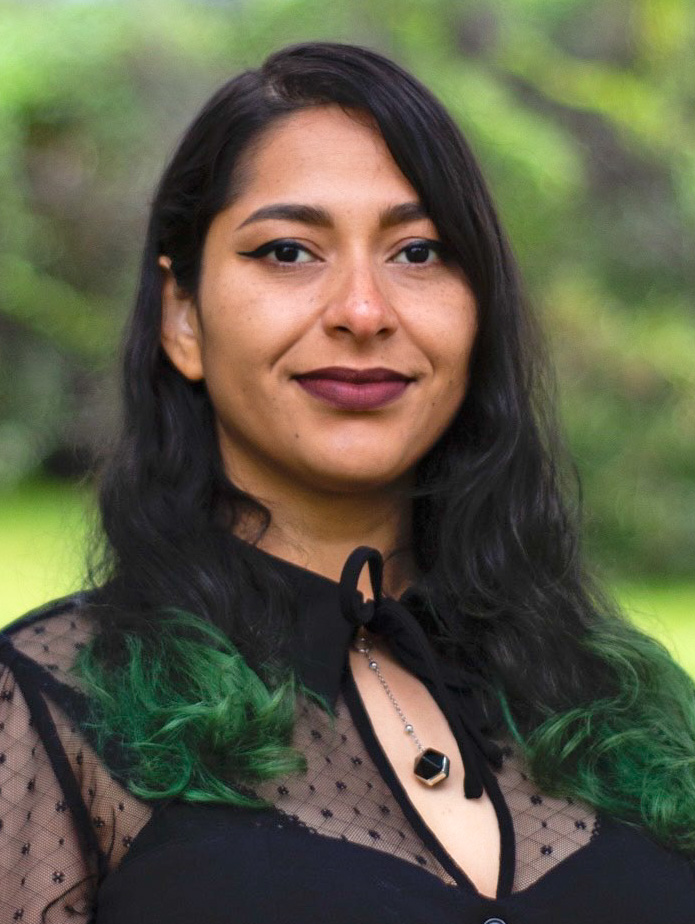 Person with long, dark hair smiling slightly.