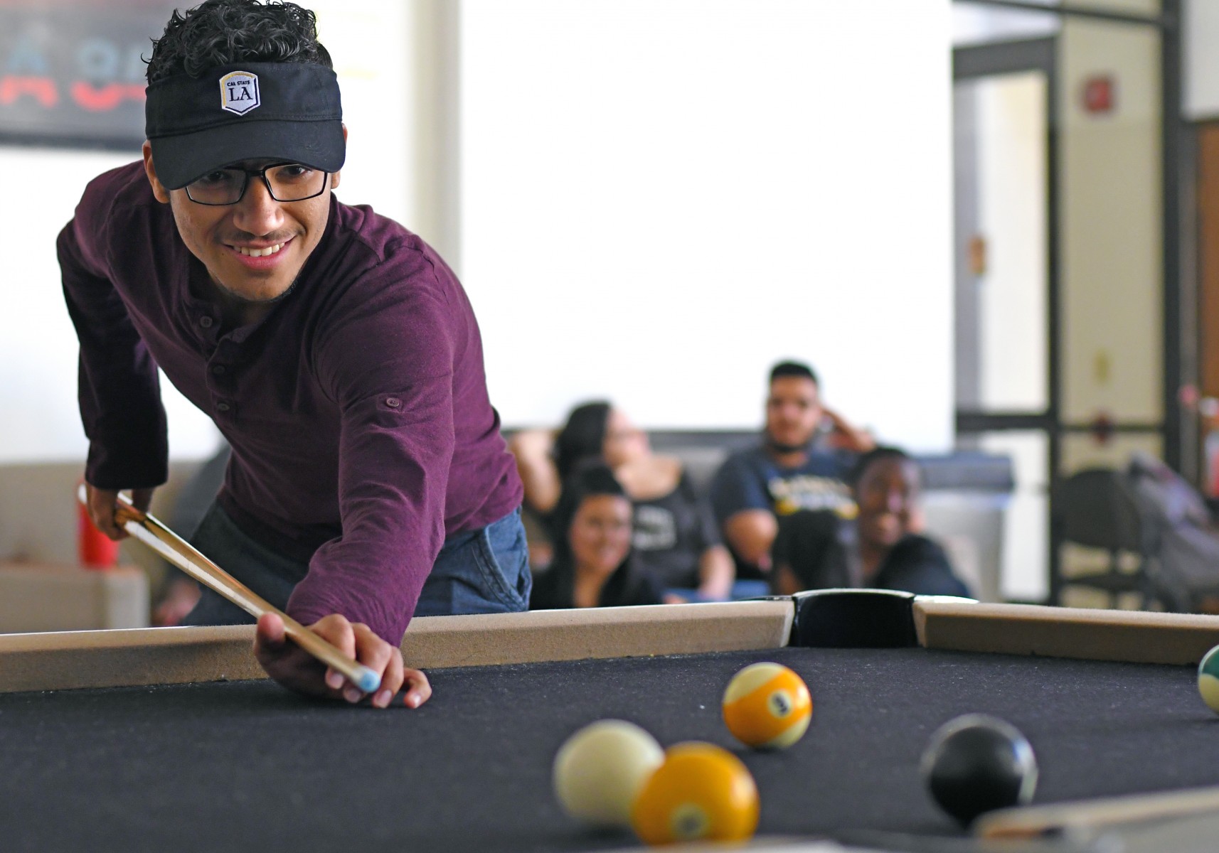 Student playing pool.