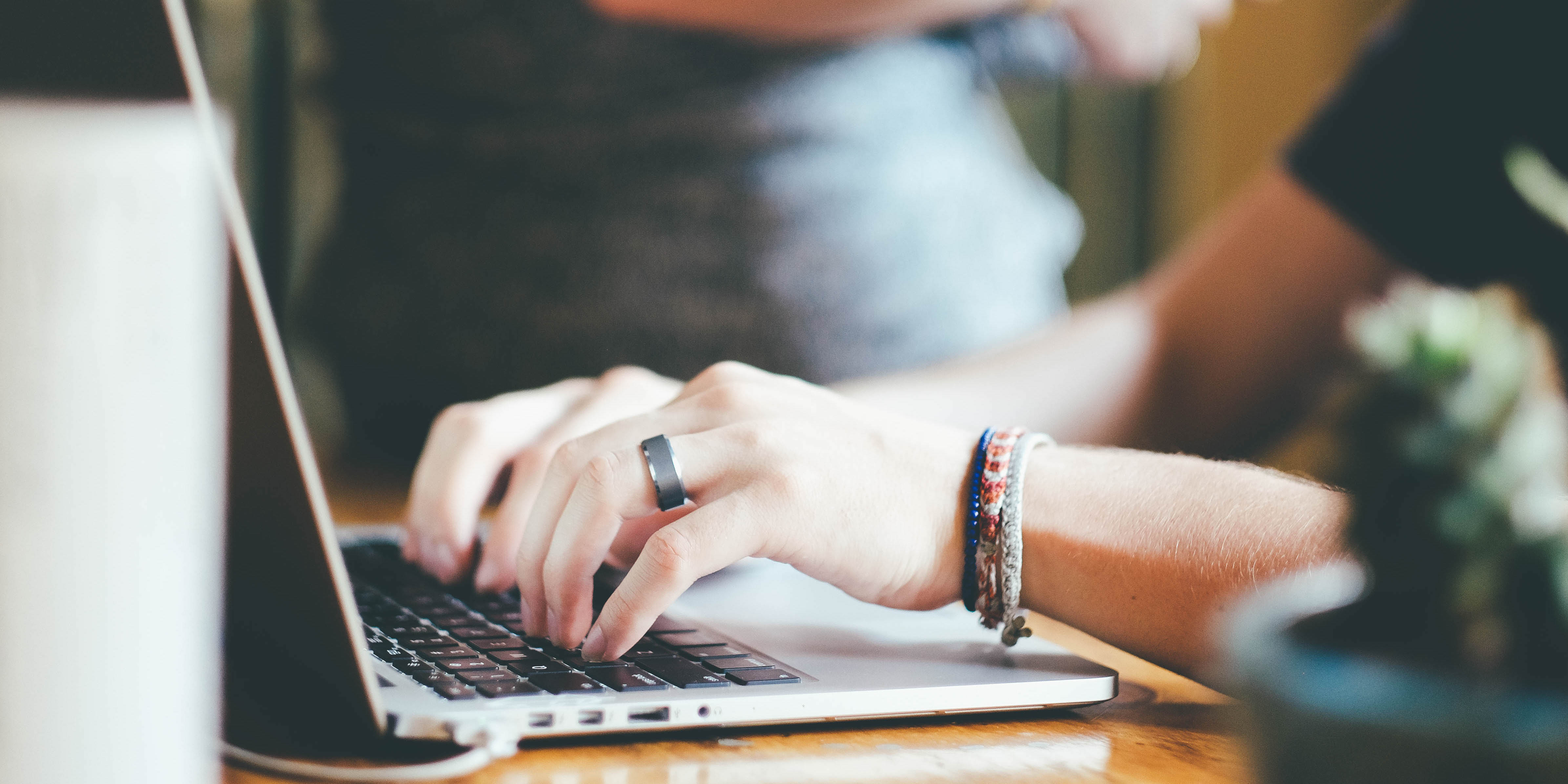 Hands typing on computer