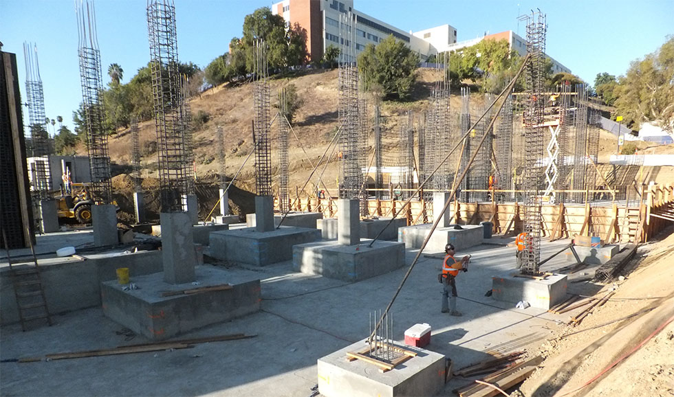 Construction workers continue to work on the new foundation and pillars.