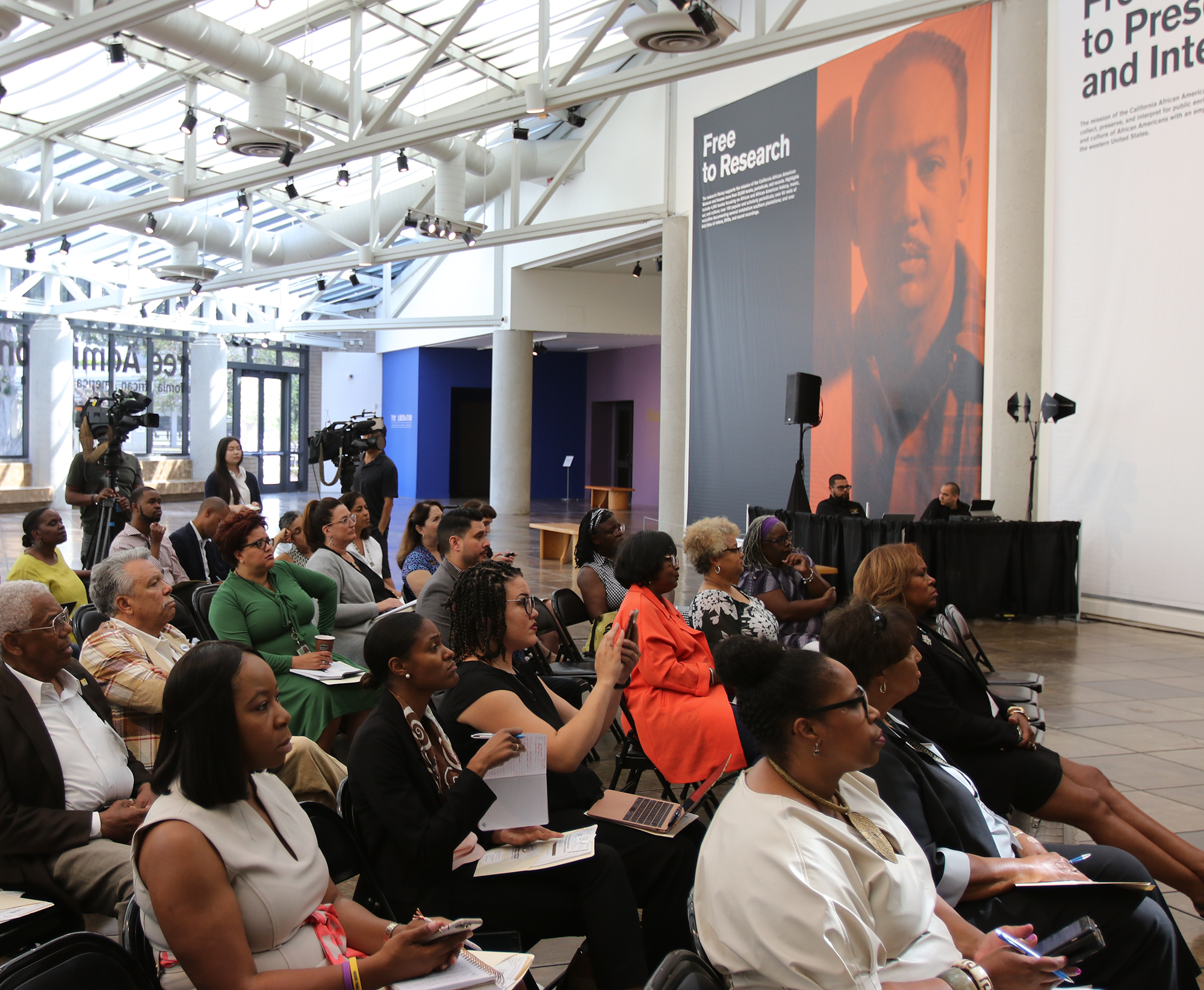 Crowd listens to the poll findings at the event