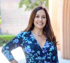 Cynthia Casteneda in a blue dress standing outside.