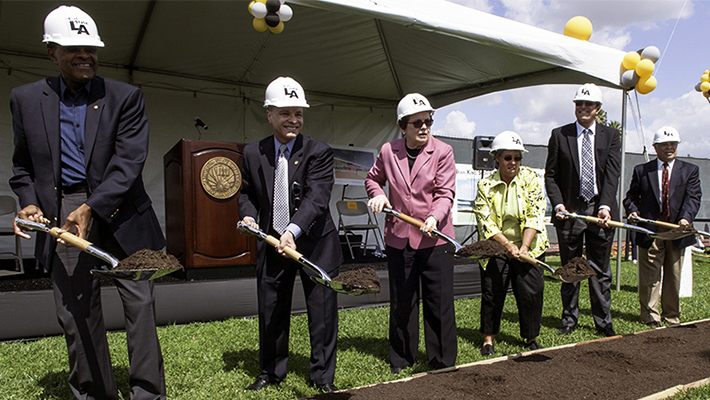 Former Cal State L.A. president James M. Rosser, President Covino, alumna Billie Jean King, tennis legend Rosie Casals, Gregory Gonzales and Daniel Gonzales break groun at the tennis center.