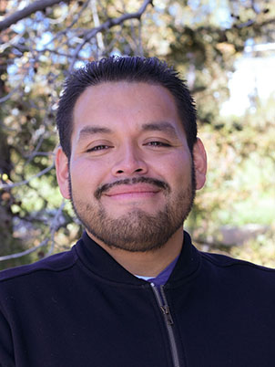 Man smiling and posing for a portrait.