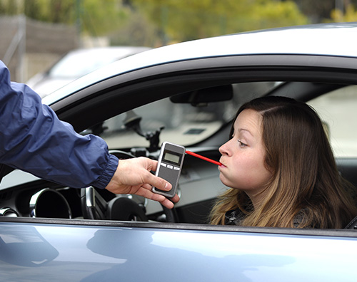 A young woman being tested for blood alcohol level