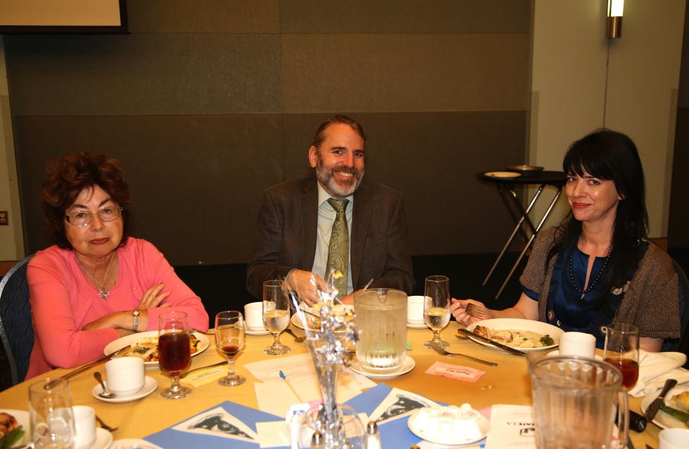 Dominita Dunitrescu, Scott Wells, and Maria Magolske sitting at table