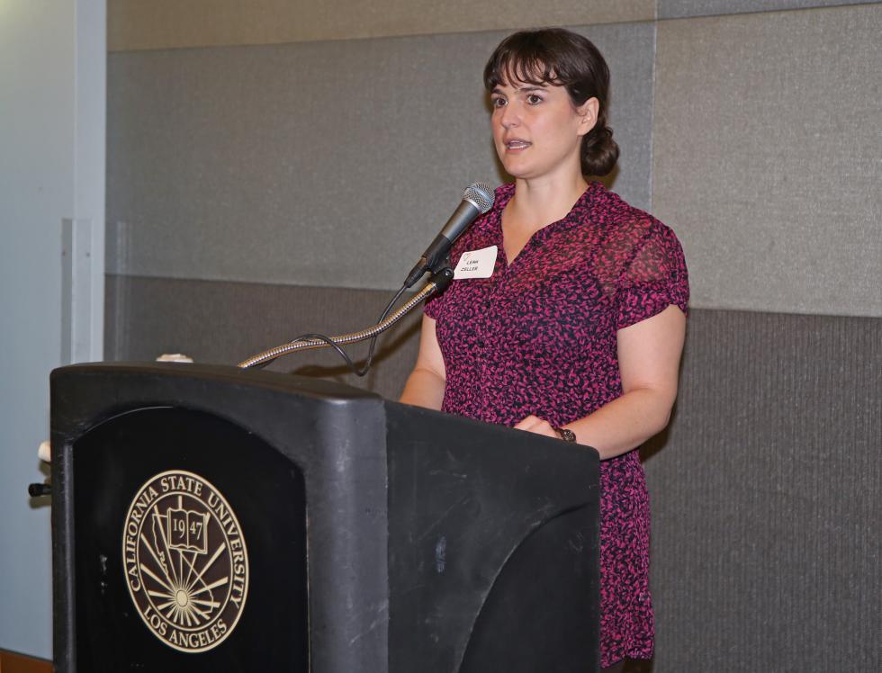 Leah Zeller,woman wearing dress/flowers,standing behind podium 