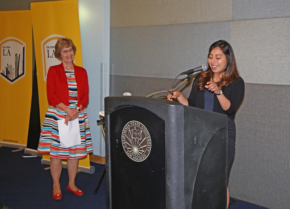 Marilyn Friedman, Carina Vasquez behind the podium 