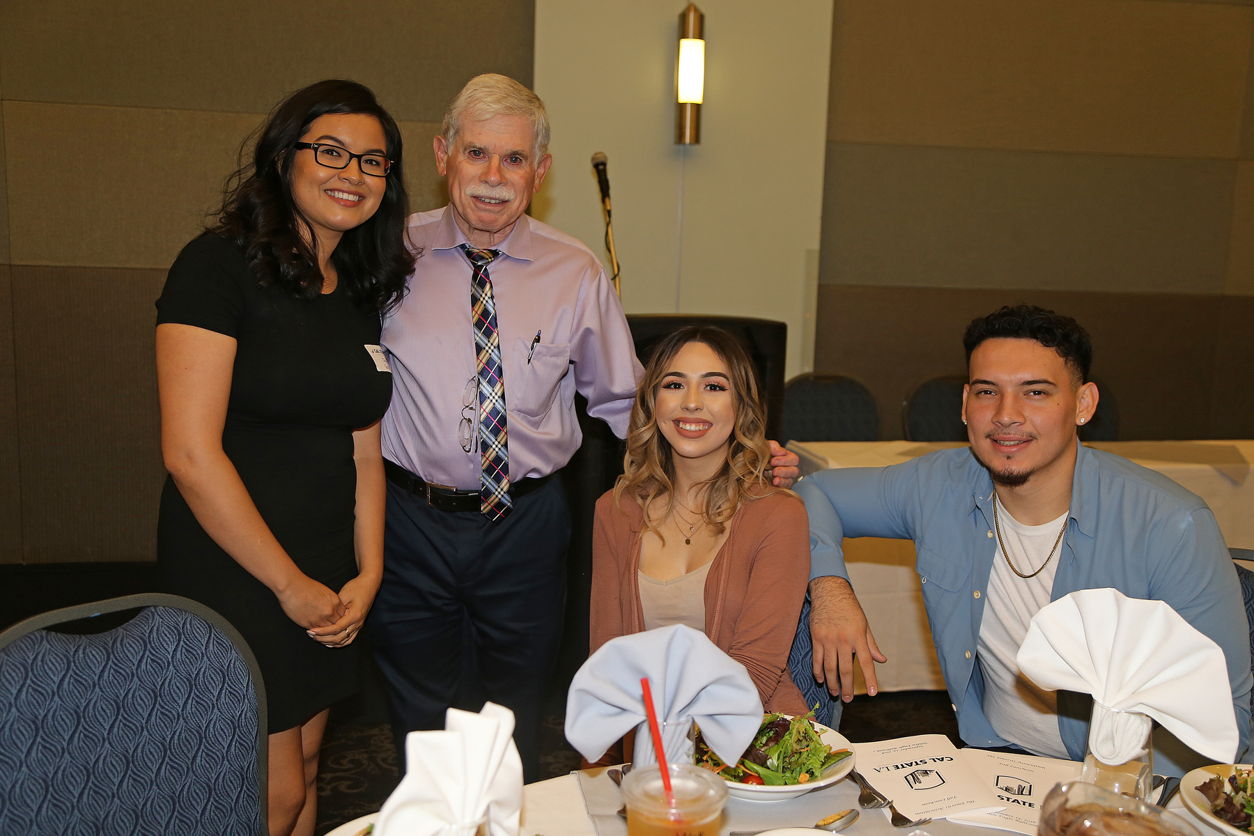 three students with professor at Fall 2017 luncheon