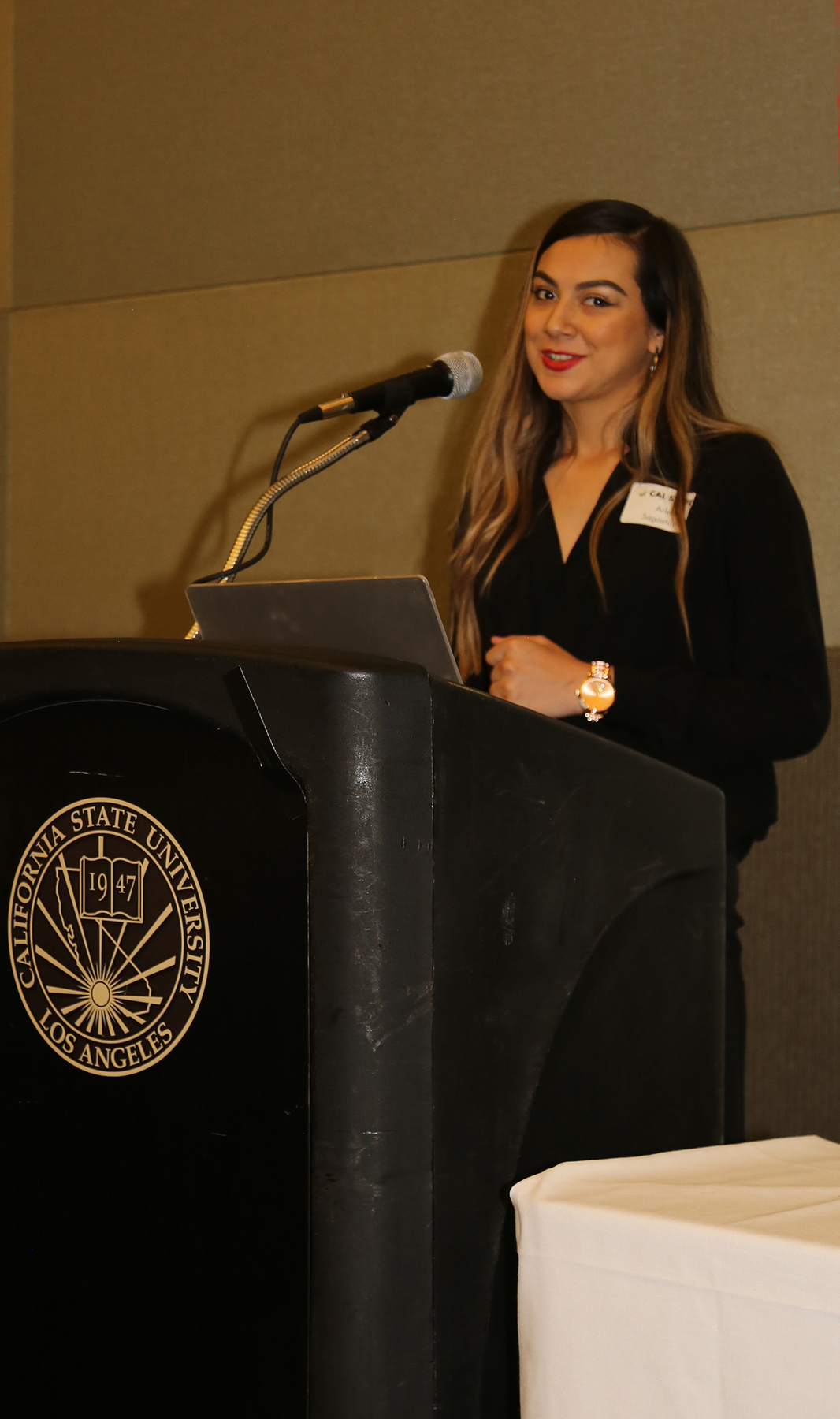 Female Student at podium at fall luncheon