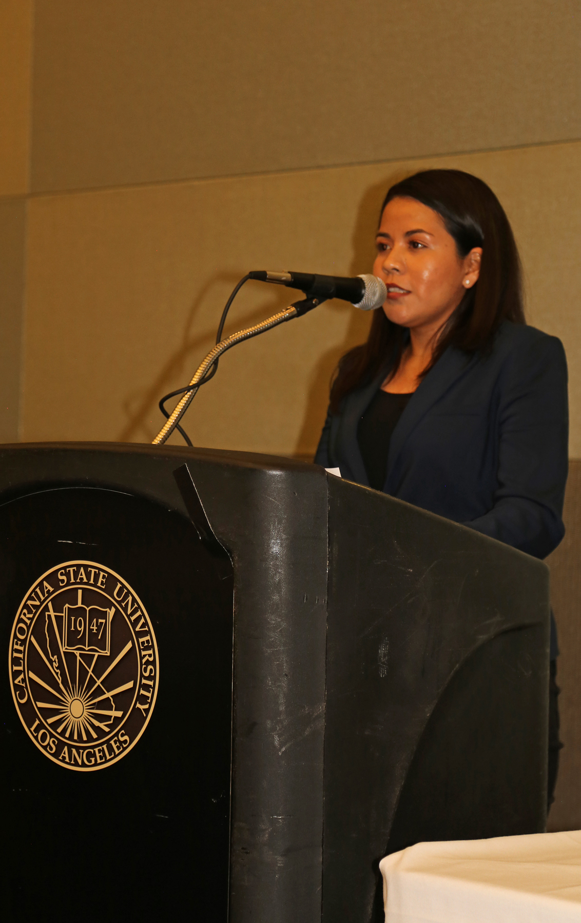 Female Student at podium at fall luncheon