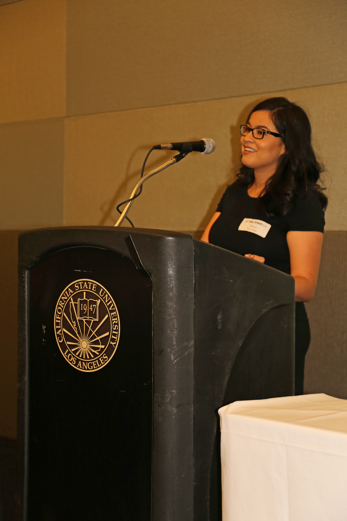 Female Student at podium at fall luncheon