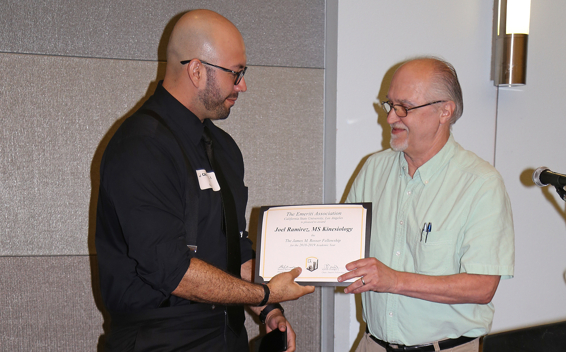 Joel Ramirez, student, with professor presenting award