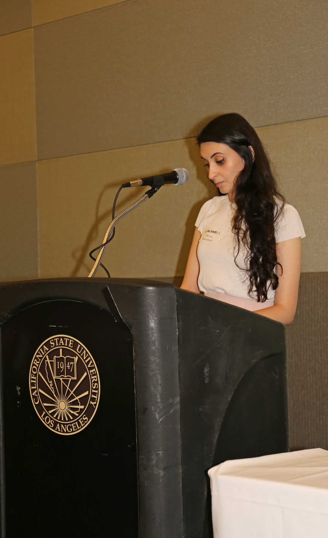 Female Student at podium at fall luncheon