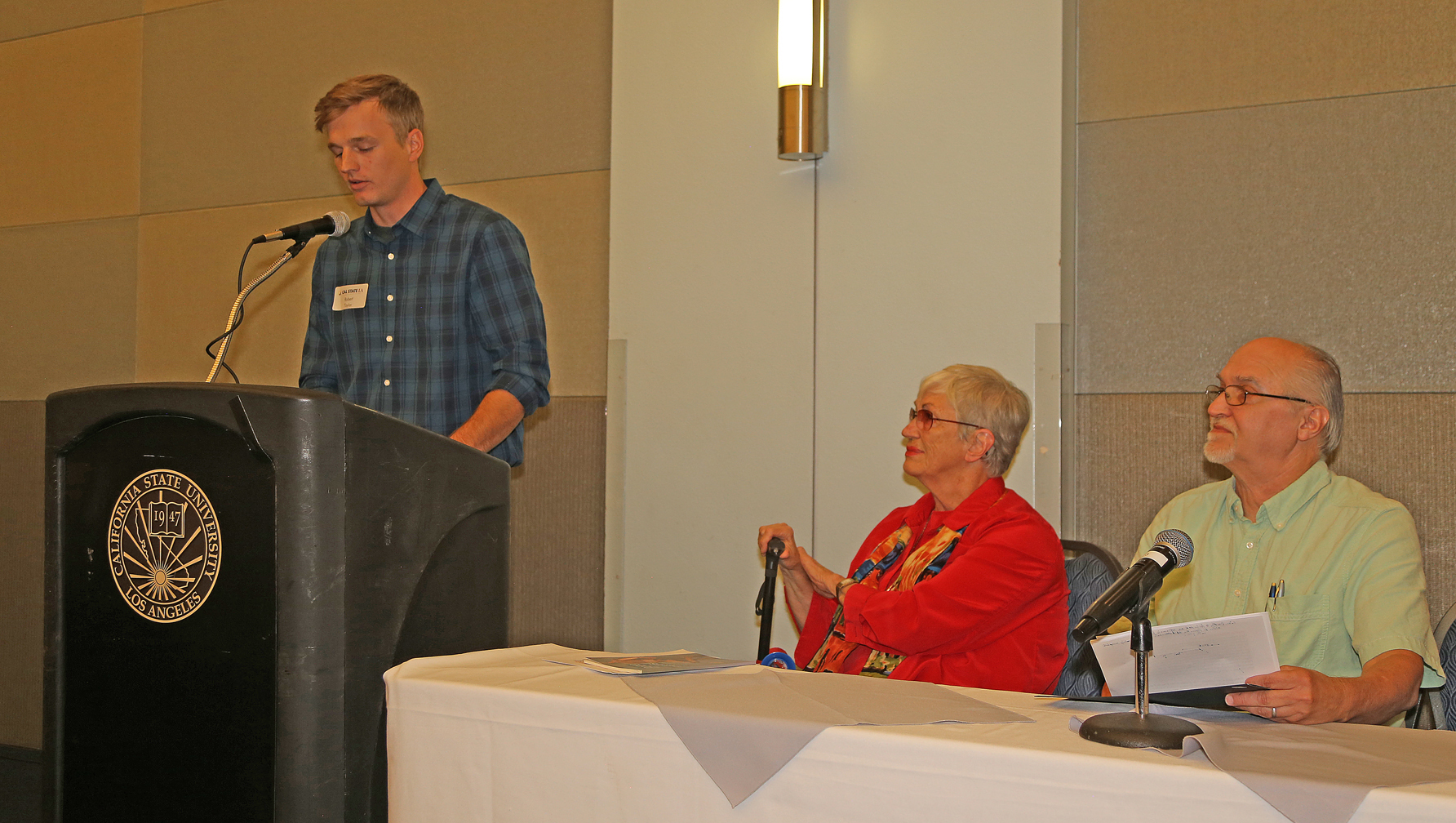 male Student at podium at fall luncheon