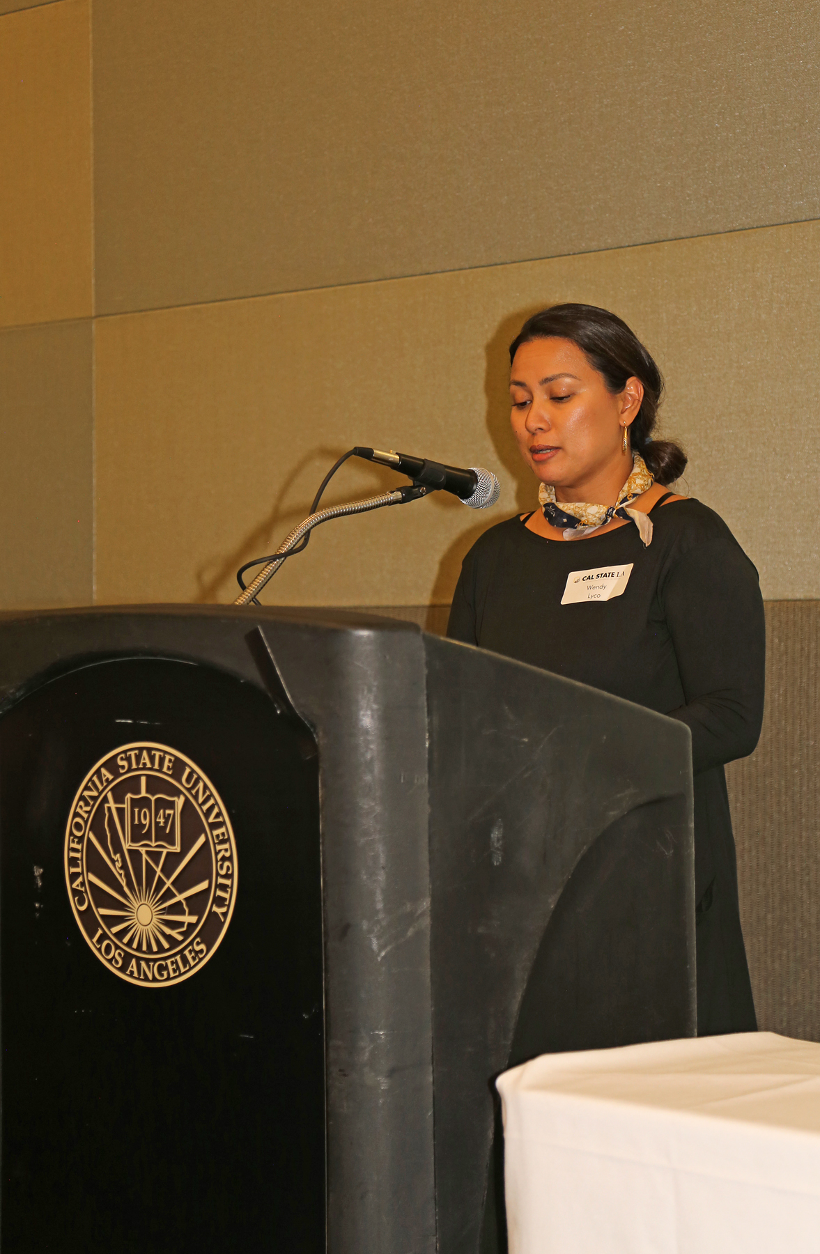 Female Student at podium at fall luncheon