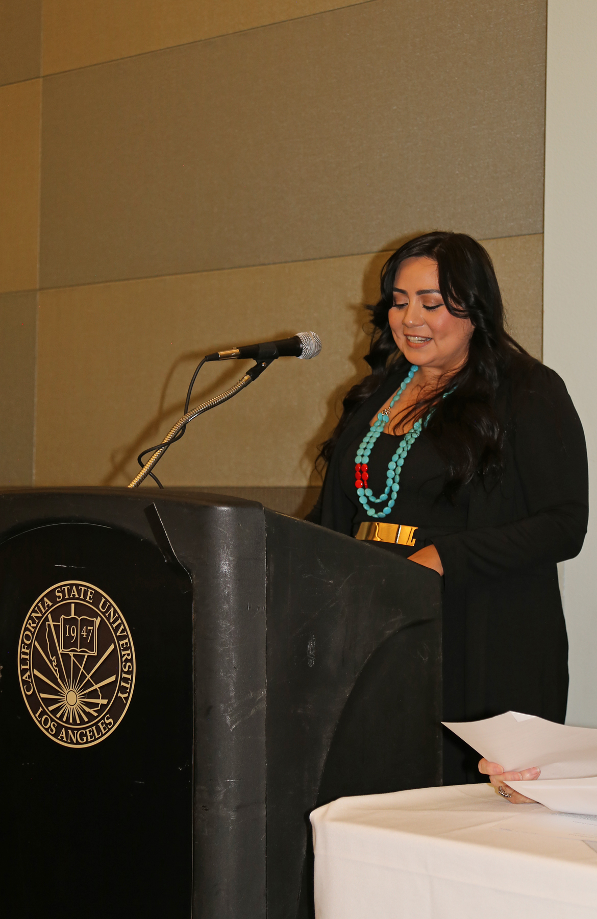 Female Student at podium at fall luncheon