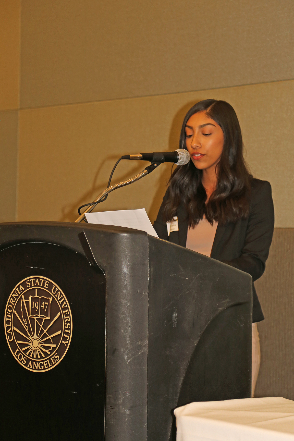 Female student at podium at fall luncheon