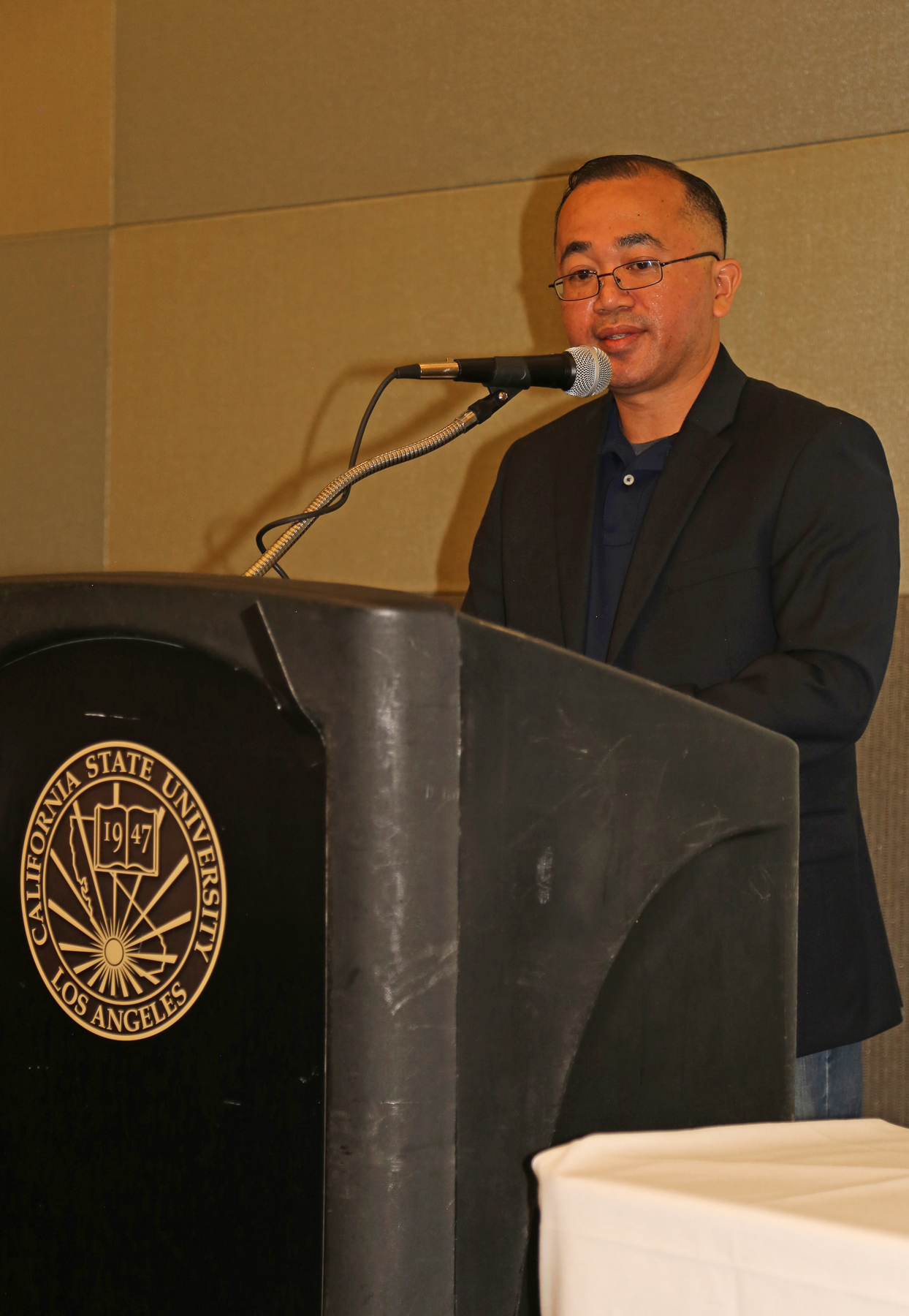 male student at podium at fall luncheon